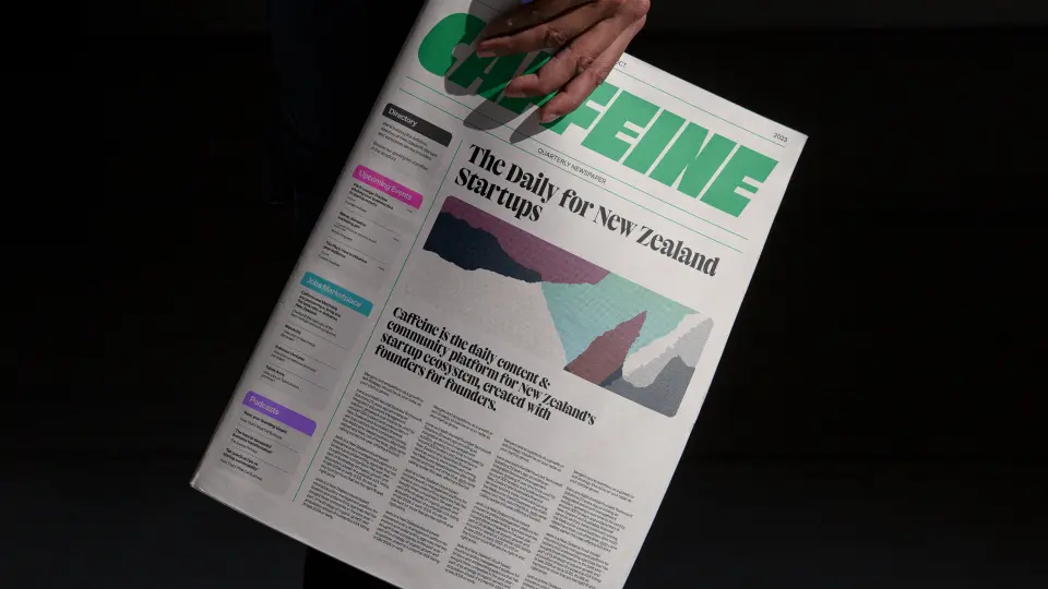 Printed magazine with a green masthead on a dark surface