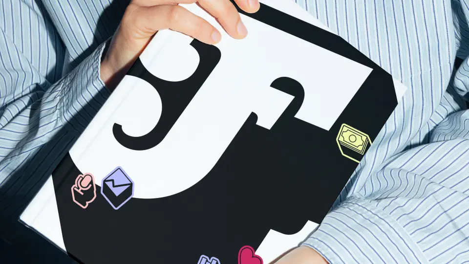 Person holding a bag with a black and white graphic logo