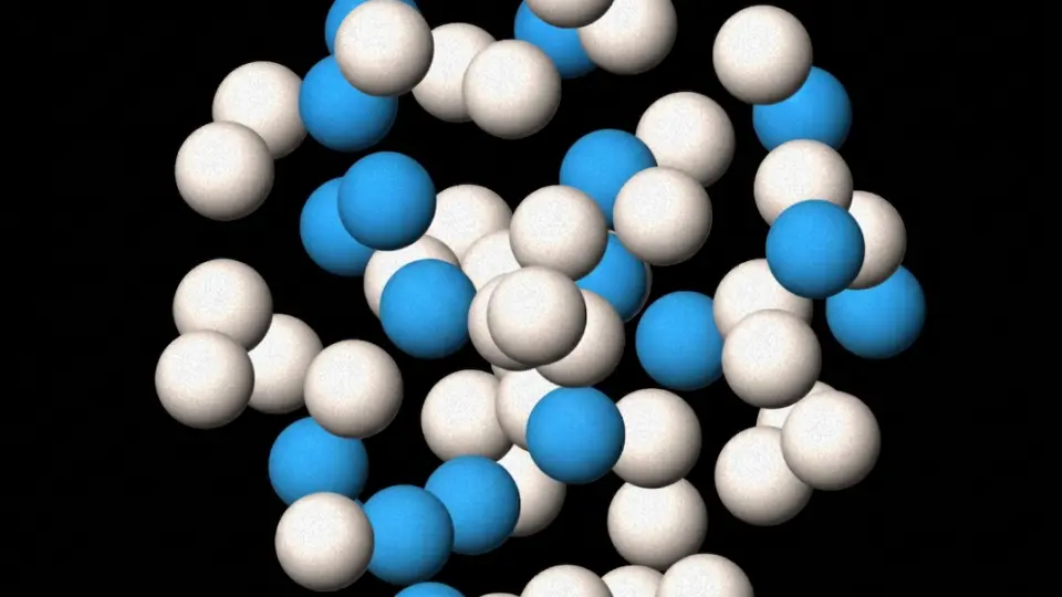 Cluster of blue and white spheres on a black background