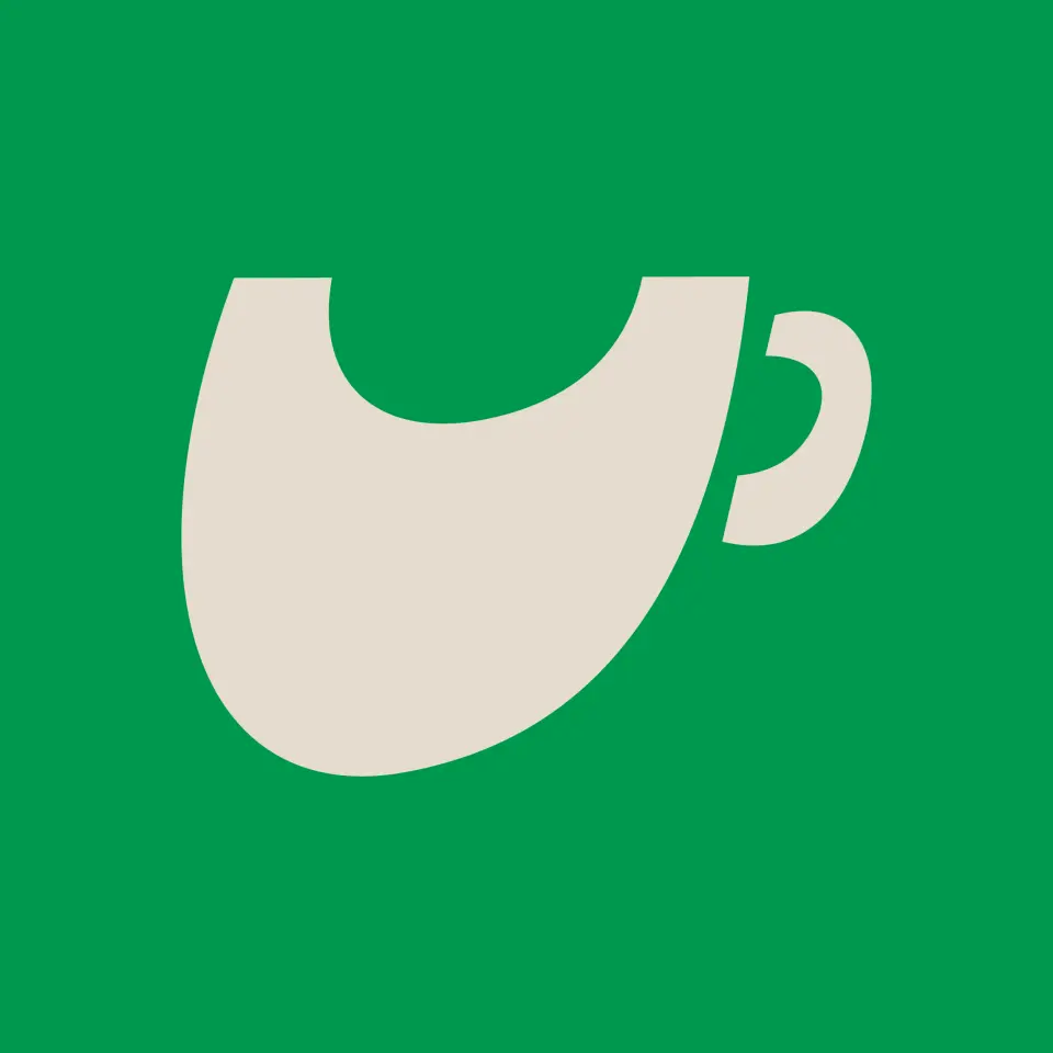 Cream coffee cup shape on a green background