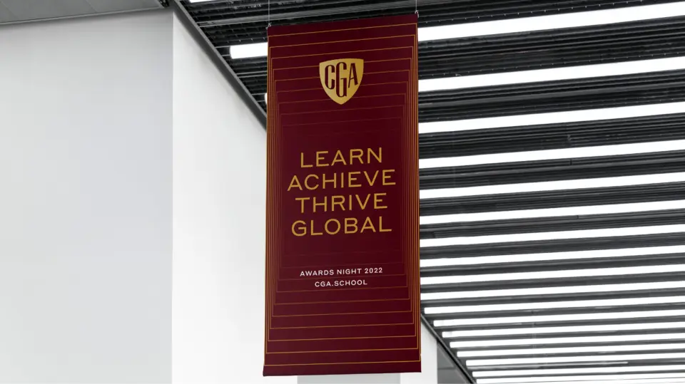 Crimson Global Academy banner hanging in a modern atrium