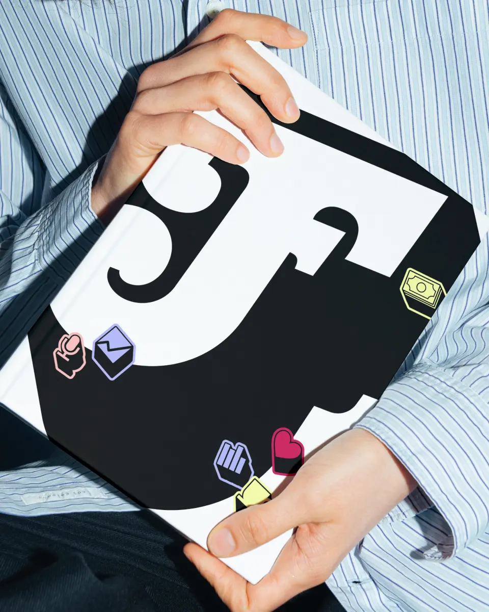 Hands holding printed Friends That Invest “F” artwork