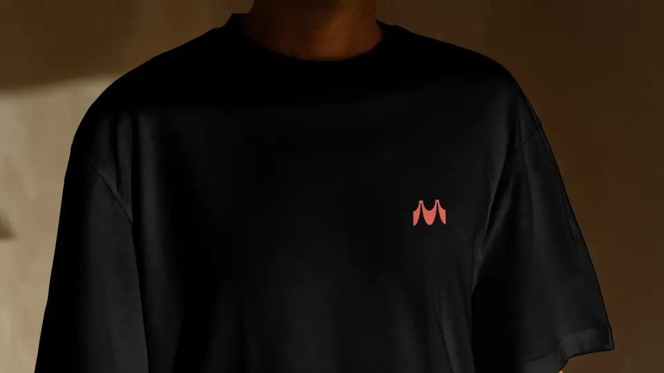 Person in a black t-shirt with a small Manifest mark