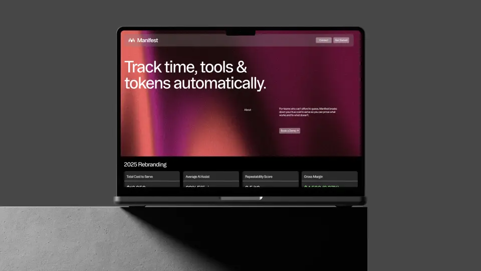 Laptop showing the Manifest website on a grey background