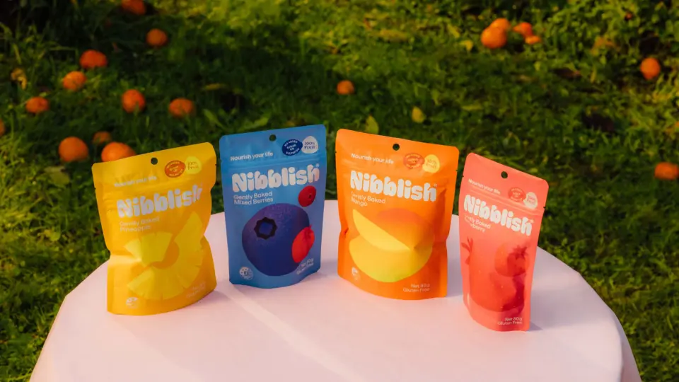 Colourful Nibblish snack pouches on a table outdoors
