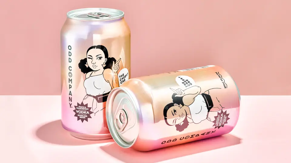 Two Odd Company cans with illustrated portraits on a pink surface