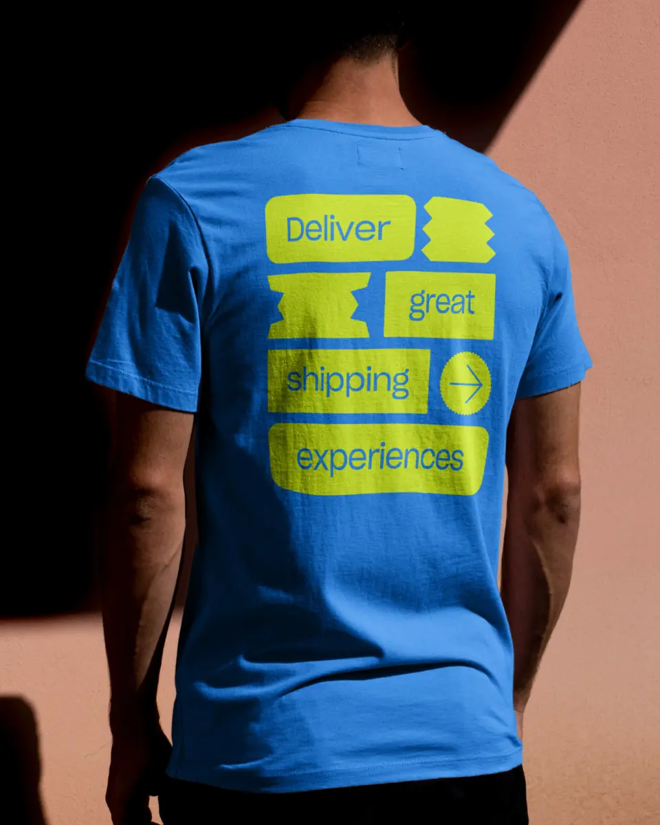 Person from behind wearing a blue Starshipit t-shirt with yellow print