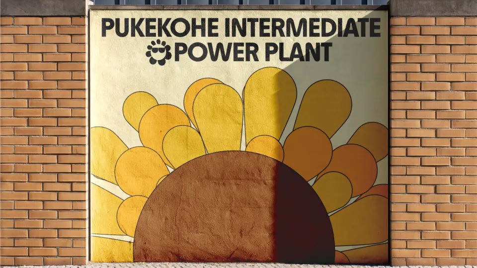 Sunflower mural on a brick school wall reading “Power Plant”
