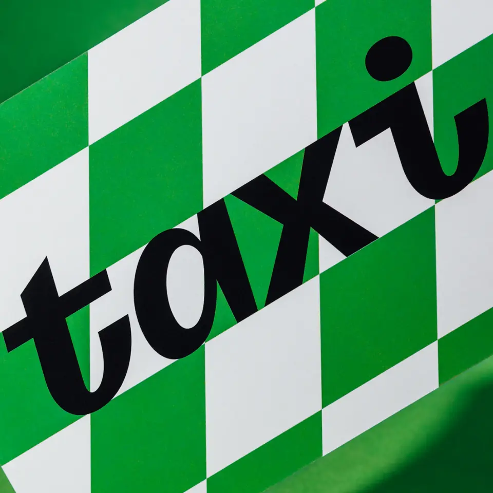 Taxi wordmark on a green and white checked pattern