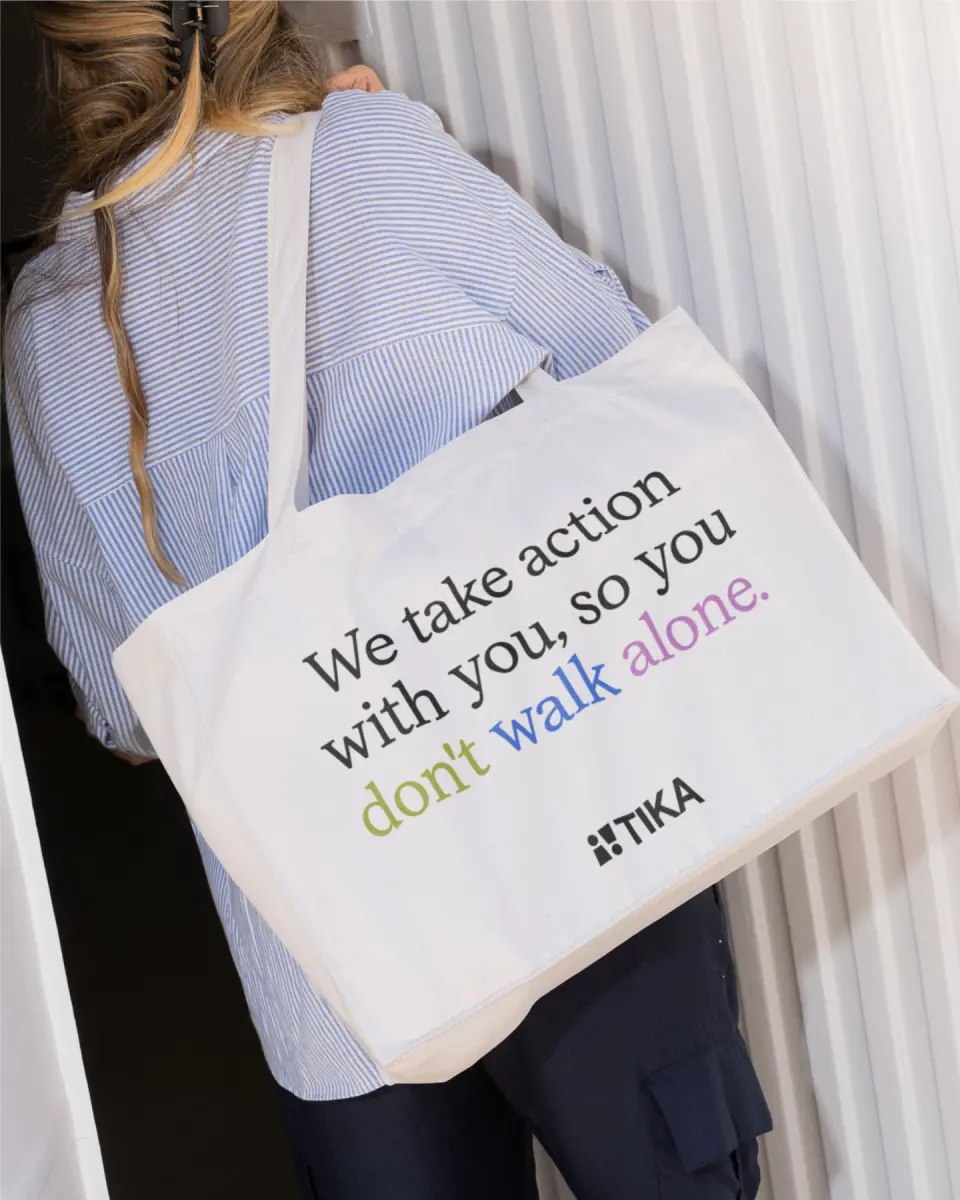 Tote bag reading “We take action with you, so you don't walk alone”
