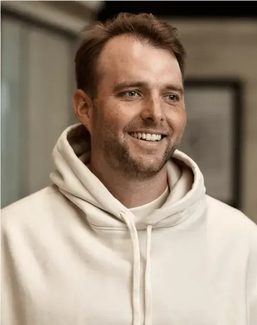 Smiling man in a cream hoodie, portrait