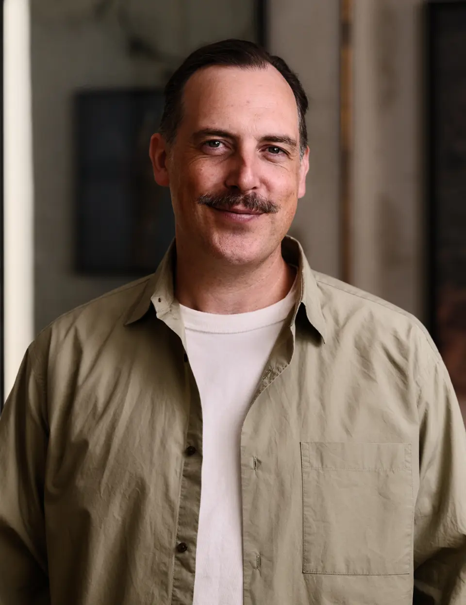Portrait of Simon Pound in an olive shirt