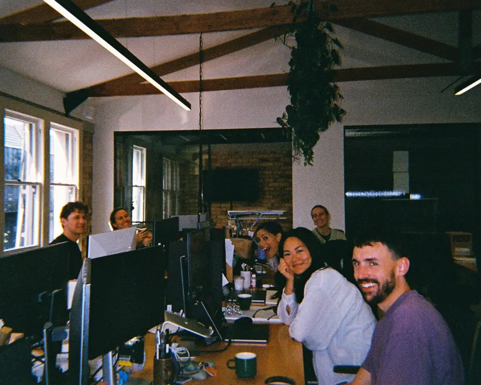 Team members working at desks in the PU studio