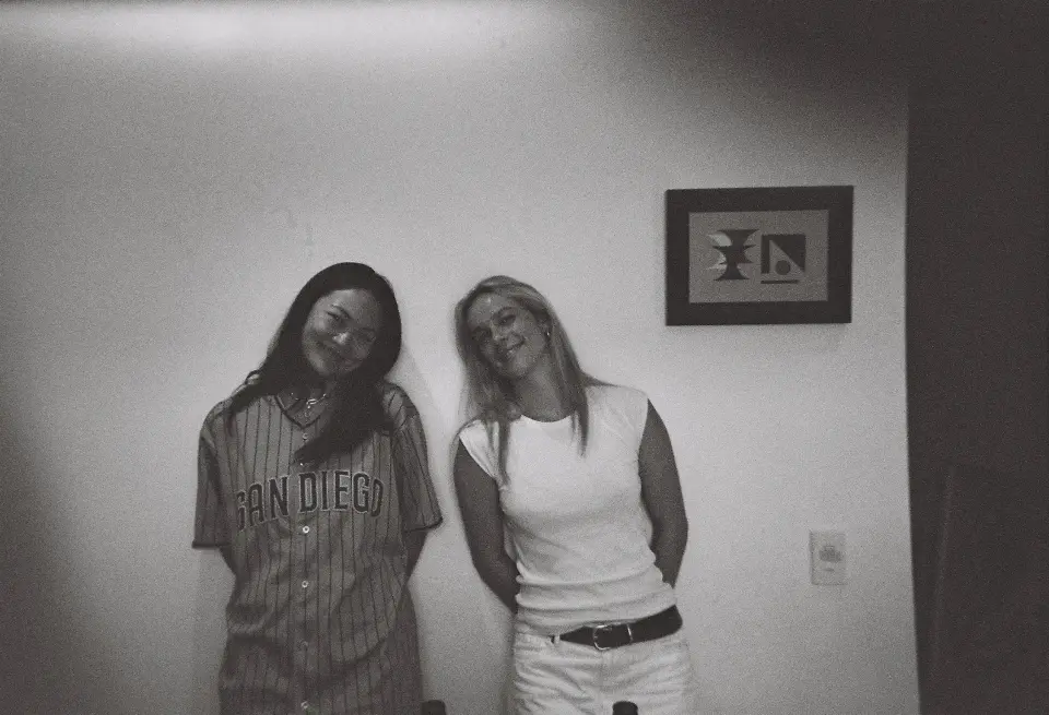 Black and white photo of two women standing together smiling